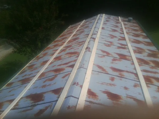 Rusted metal roof panels with new wood purlins before replacement — Storm Damage Roof Repair in Indian Wells by Roofing Brothers