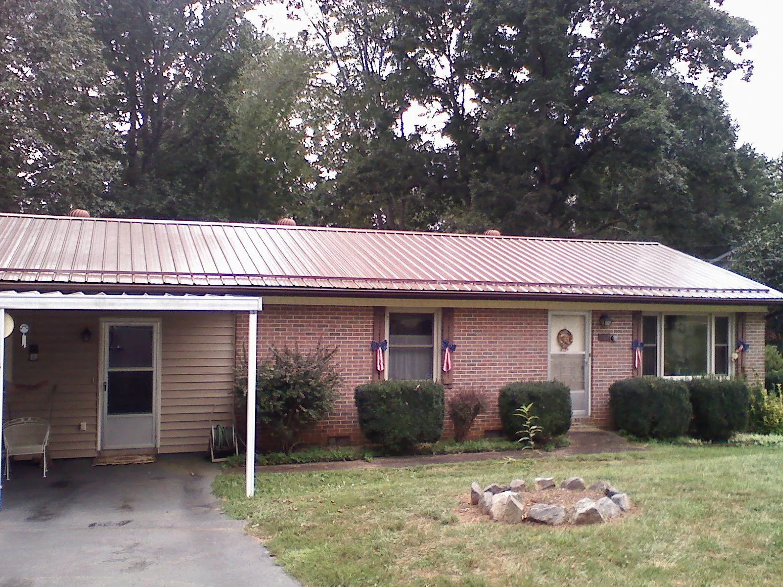 Bronze metal roof and carport on a brick ranch home — Roof Repair work by our crew in Indian Wells